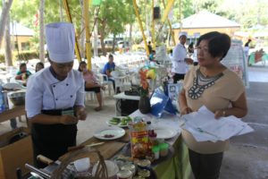 (3) Mrs. Estrella Toreta, one of the judges of Duck Meat Cooking Contest, keenly observed and ardently interviewed the participant during the start of the contest.