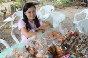 Ms. Chinee Juntilla, young entrepreneur from Padada, Davao del Sur, struck a pose together with her delicious pastry products for sale